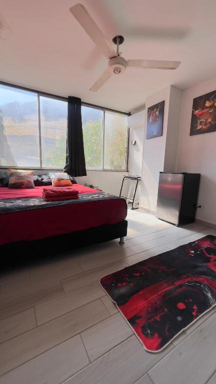 a bedroom with a bed and a large window at Rodadero Oasis in Santa Marta