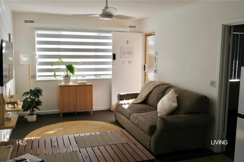 a living room with a couch and a window at Harbour Lane Stay in Geraldton