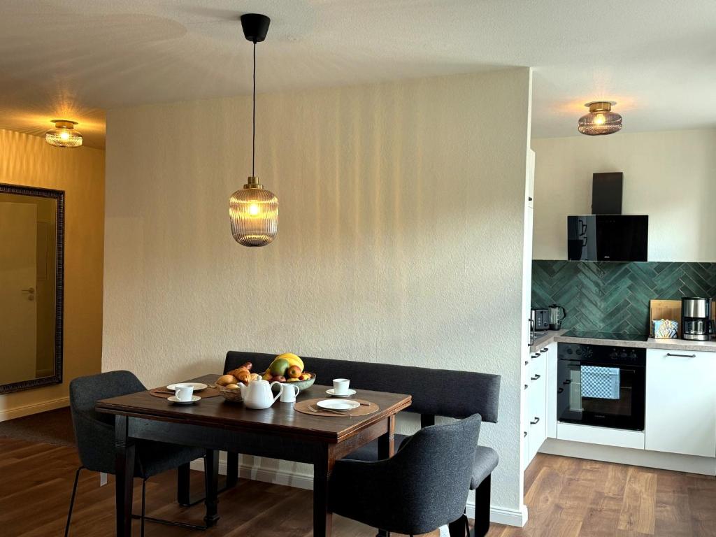 a dining room with a table and a kitchen at Bad Oeynhausen - City, Küche, Netflix, Wifi, zentral, StudioApartment in Bad Oeynhausen