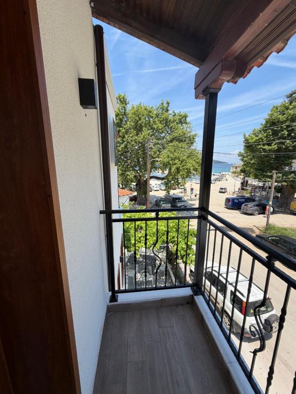 a balcony with a view of a parking lot at ThasosGoldenStay in Skala Potamias