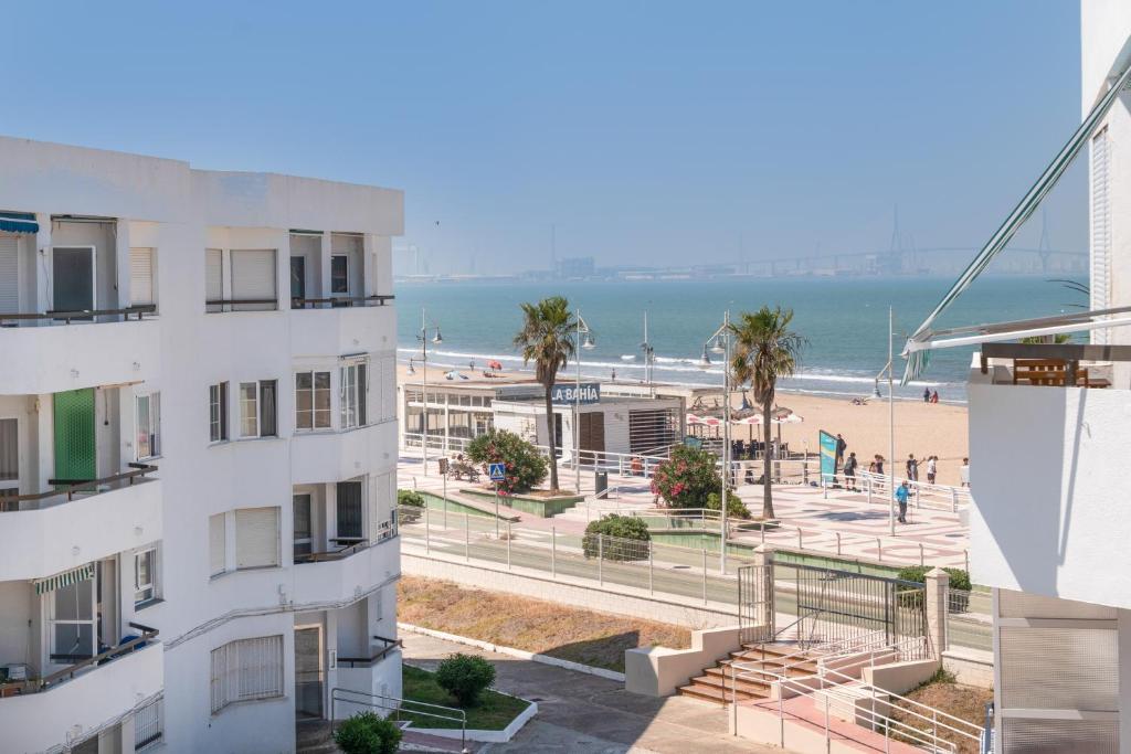 a view of the beach from the balcony of a building at Valdelagrana en Primera Linea in El Puerto de Santa María