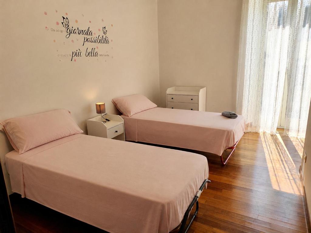 a room with two beds and a window at La Perla di Sulmona in Sulmona
