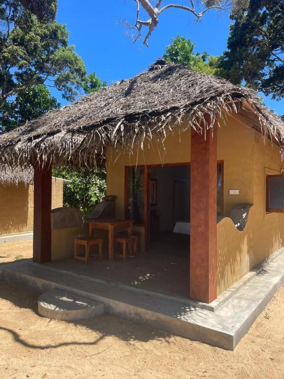 a small hut with a straw roof at Peanut Farm Cabanas -Surf in Panama