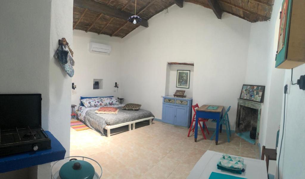 a living room with a bed and a fireplace at Antica Verdureria in Terme di Castel Doria