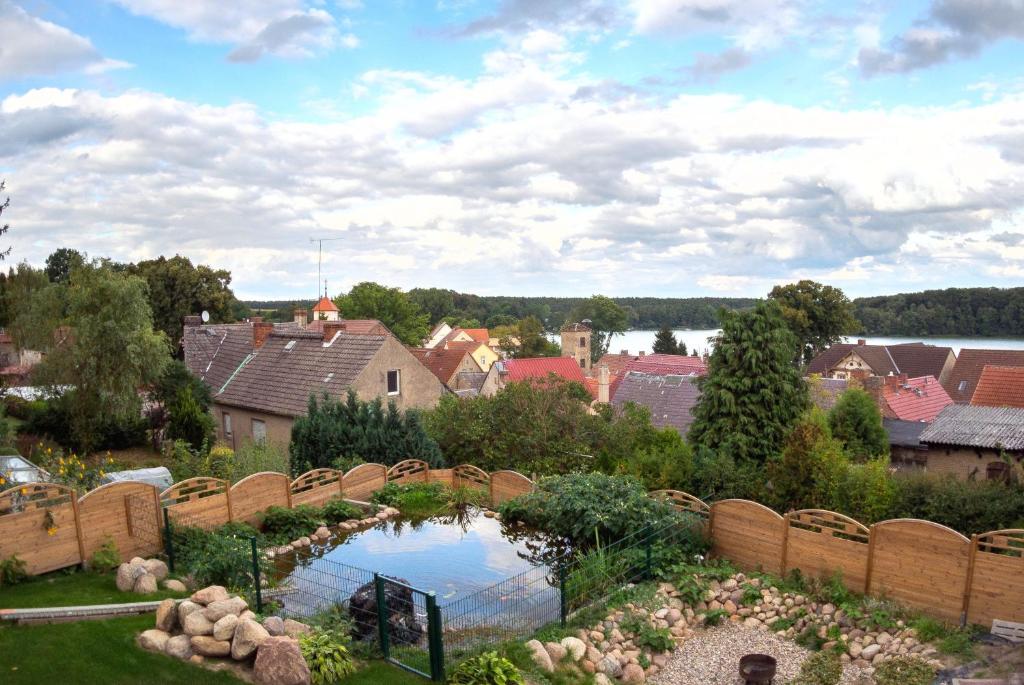 a garden with a pond in the middle of a city at Ferienwohnung mit Seeblick in Rheinsberg