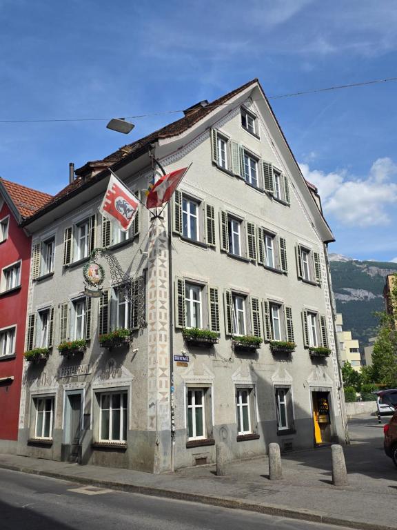 a large white building with a sign on it at Haus zum Rütli in Chur