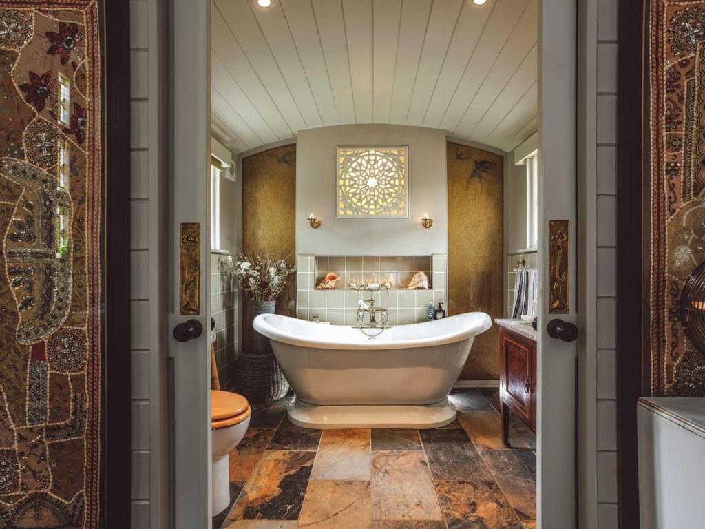 a bathroom with a tub and a toilet at The Challoners in Robertsbridge