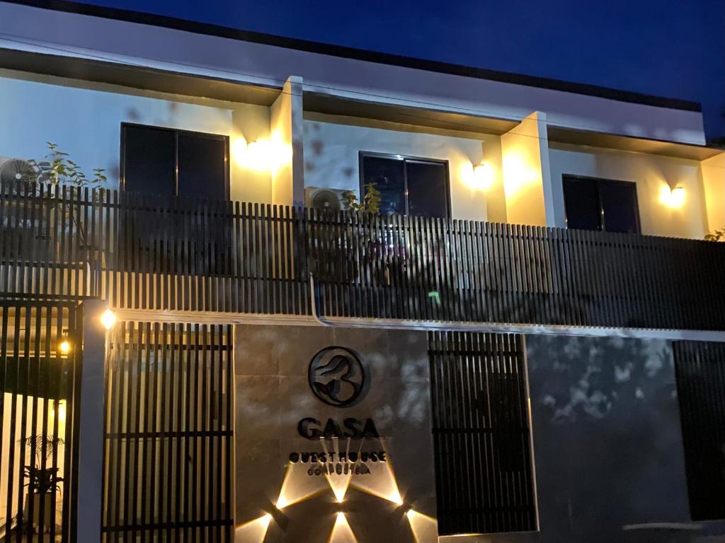 a building with a fence with lights on it at GASA Guesthouse in Compostela