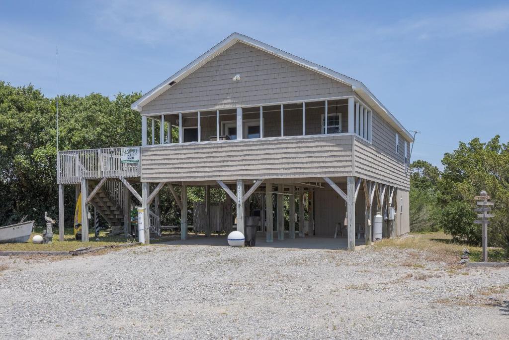 a large wooden house with a balcony on top at 7630 - Obx Box in Avon