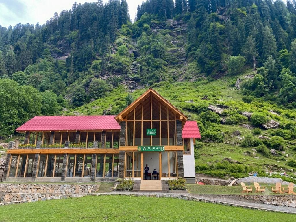 a building in front of a mountain at Woodland Resort in Naran