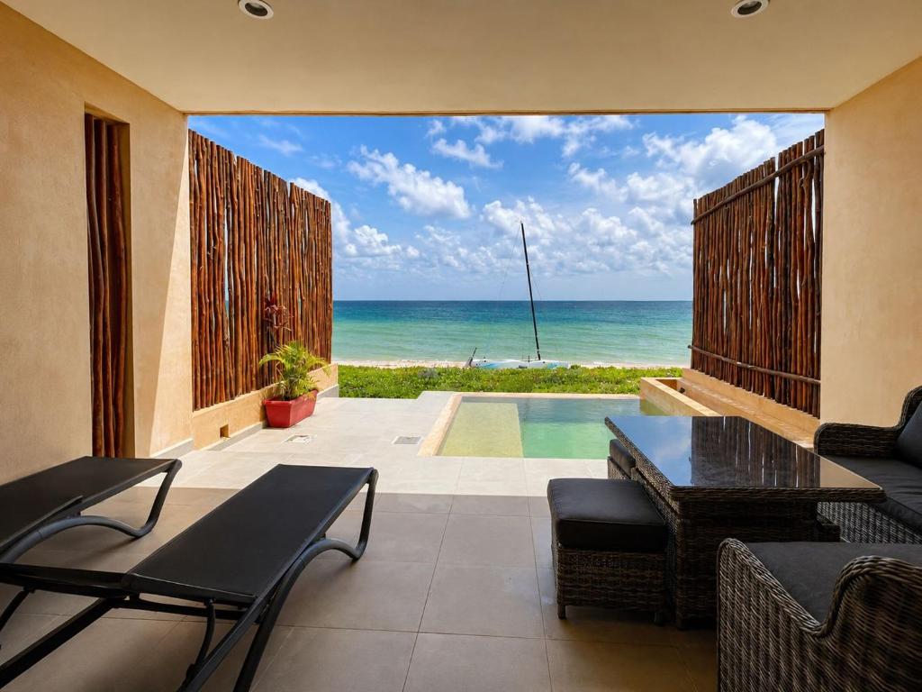 a living room with a view of the ocean at Private villa among palms in Telchac in Telchac Puerto