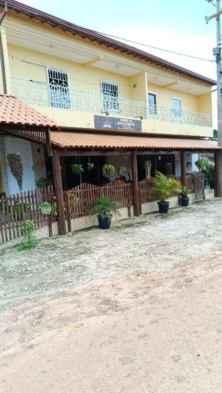 a building with potted plants in front of it at Maria do Bairro in Guaraciaba do Norte