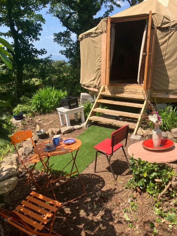 a tent with a table and chairs in a yard at Adorable Yurt Glamping Bantry in Bantry