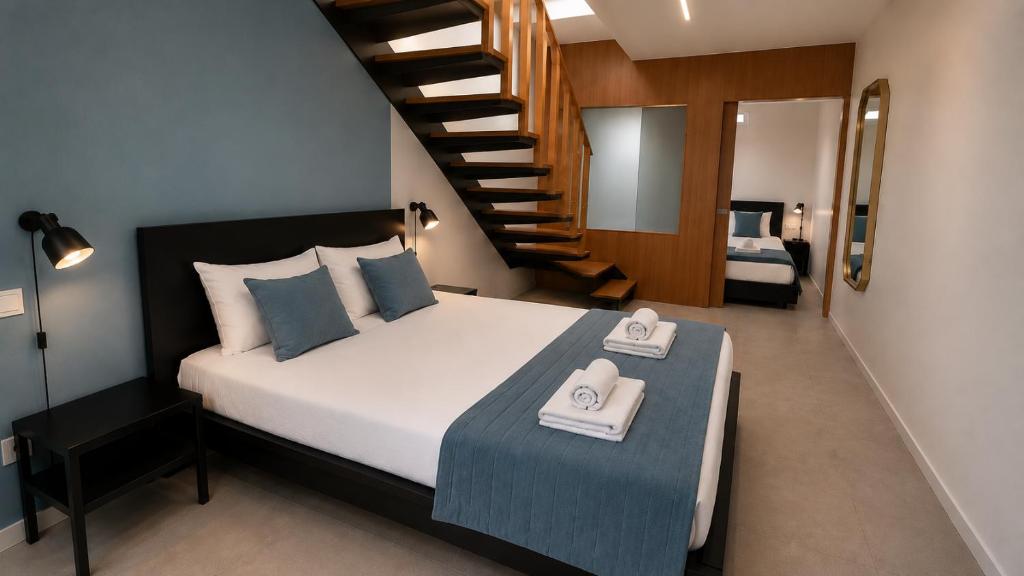 a bedroom with a bed with two towels on a table at SociaLodge - Piornais in Funchal