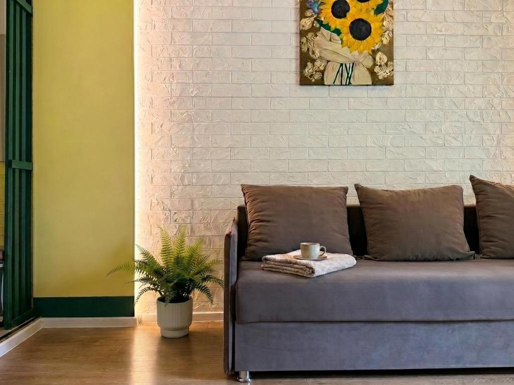 a couch in a living room with a painting on the wall at New stail centru in Bălţi
