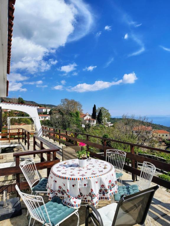 a table and chairs on a patio with a view of the ocean at Pelion country house in Volos