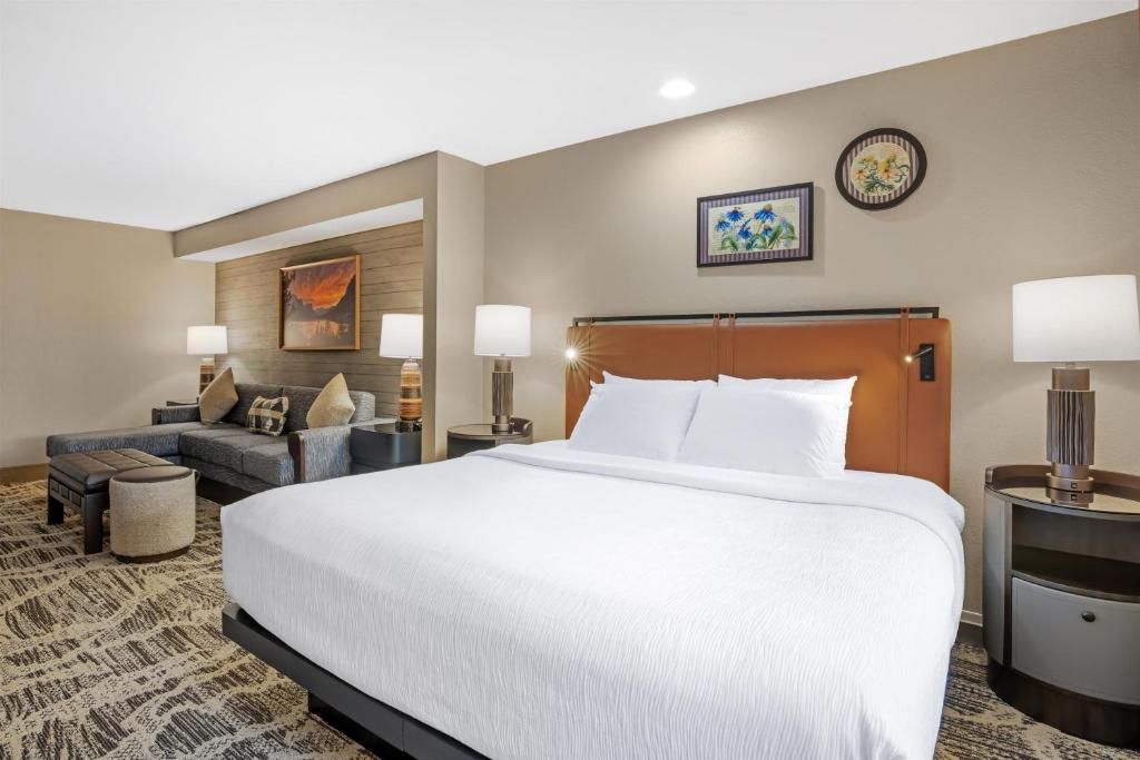 a hotel room with a large bed and a couch at Best Western Plus GranTree Inn in Bozeman