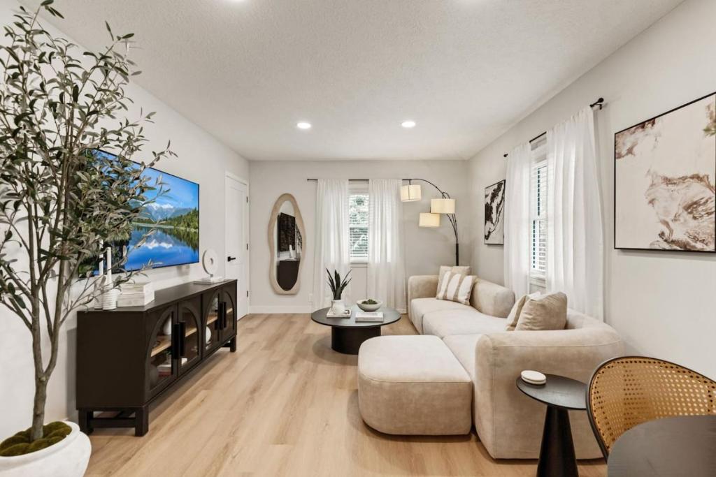 a living room with a couch and a tv at The Luxury Haus in Grove City