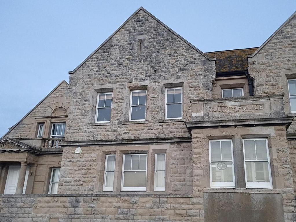 an old brick building with a sign on it at Castle Road in Castletown