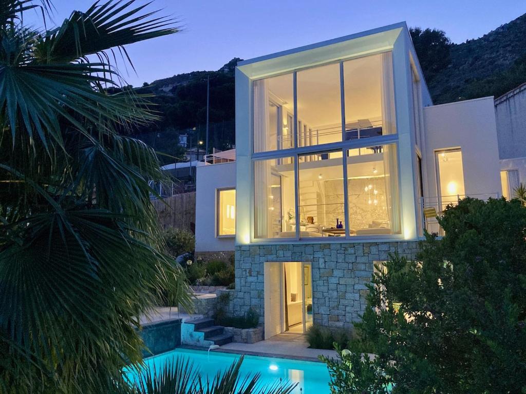 a house with a pool in front of it at Villa Mirano in Éze