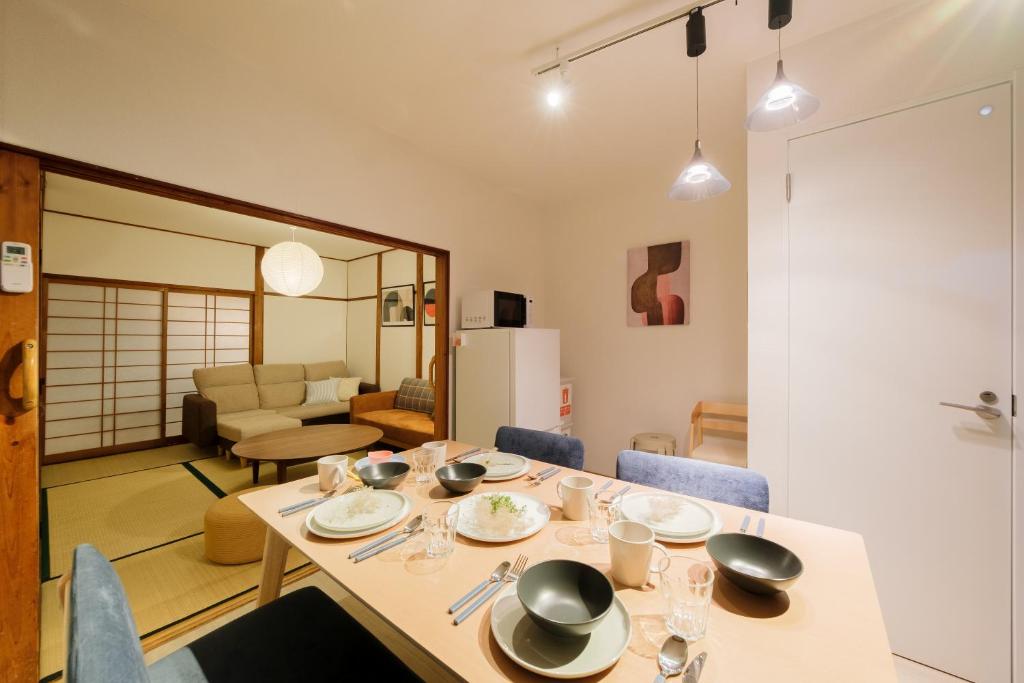 a dining room table with chairs and a living room at Castle Land NAGOYA Family Friendly 5min from Station in Nagoya