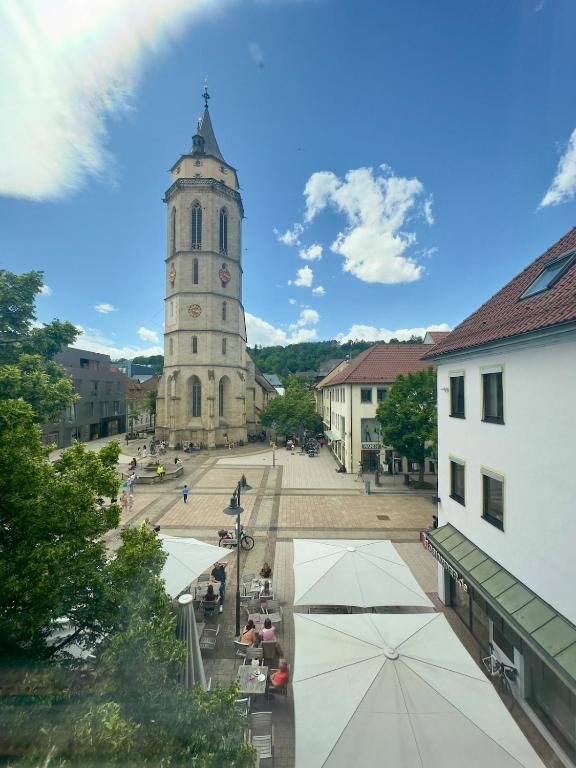 an old building with a clock tower in a town at TIME OUT Apartments in Balingen