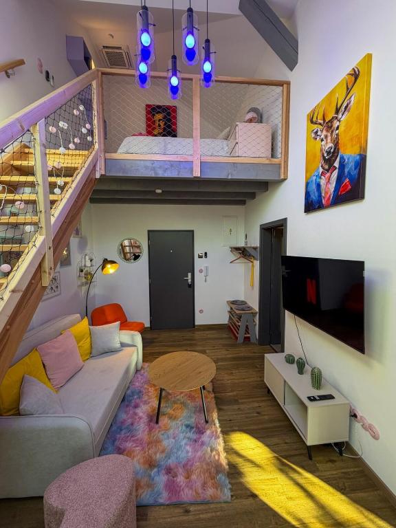 a living room with a couch and a bunk bed at Barevný úlet - Písek in Písek