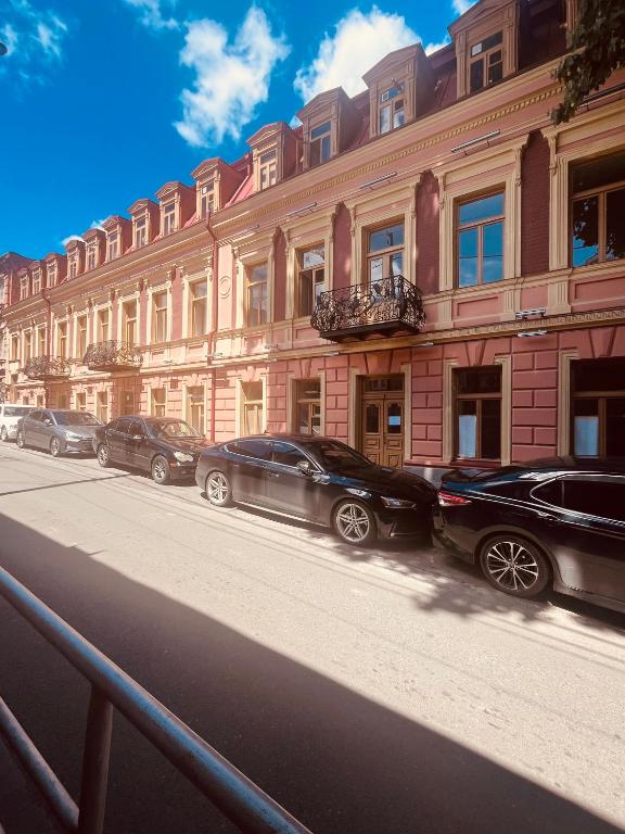 a row of cars parked in front of a building at One bedroom apartment in Tbilisi City