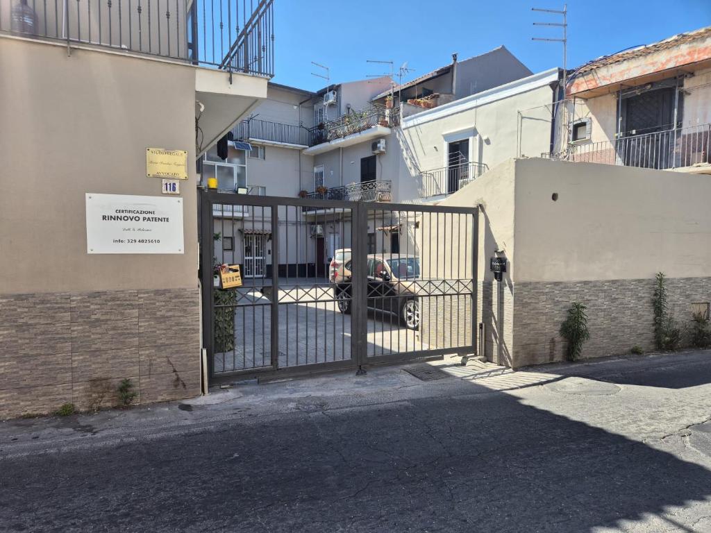 a gate in front of a building with a car behind it at Tommy House CTA in CTA