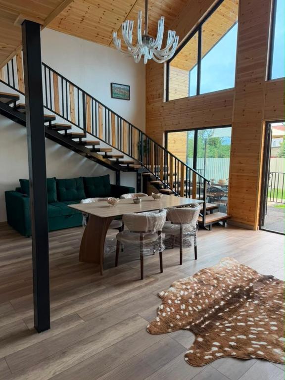 a dining room with a table and a staircase at The Barn in Cholpon-Ata