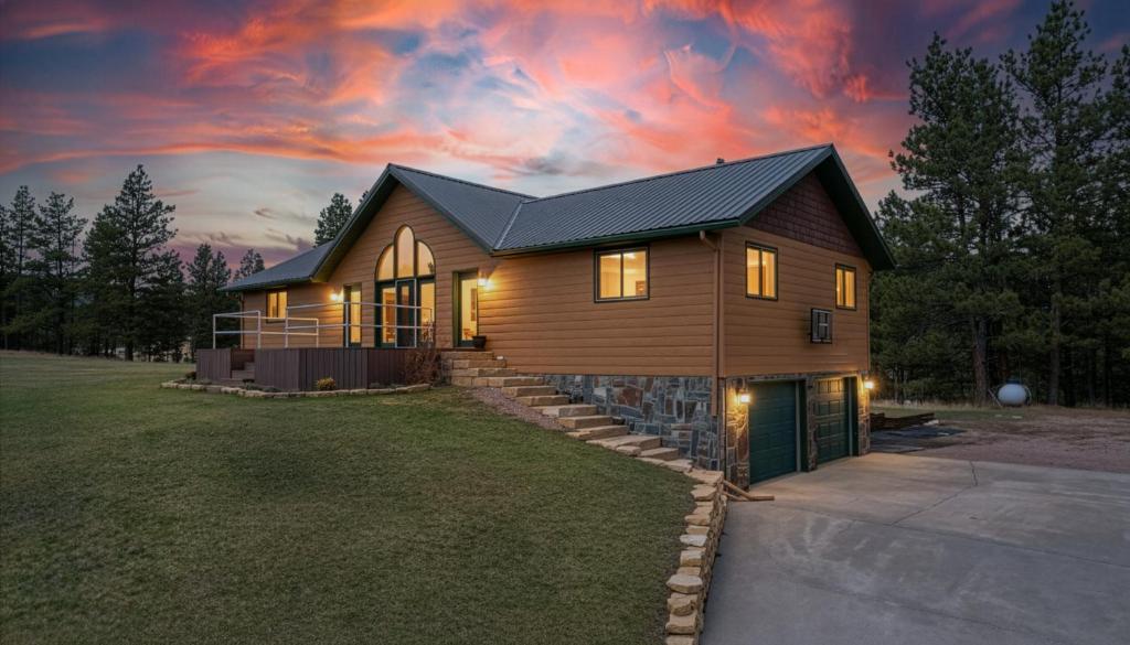 a house with a dark roof on a lawn at Song Bird Hill in Hill City