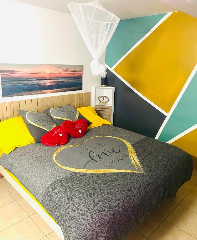 a bedroom with a bed with two stuffed animals on it at Escale verdoyante in Petit-Bourg