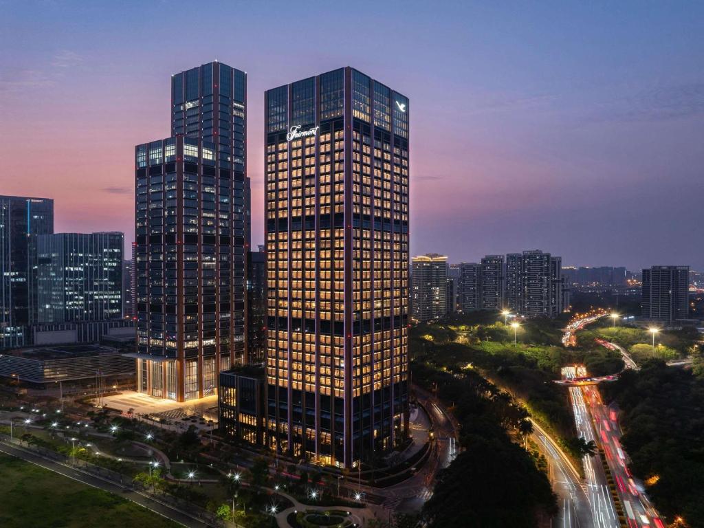a tall building in a city at night at Fairmont Xiamen in Xiamen