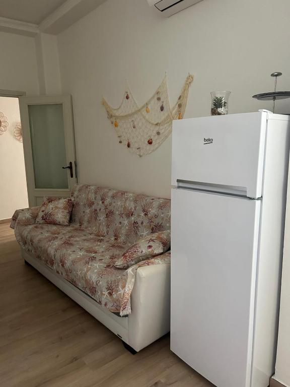 a living room with a couch and a refrigerator at MareMare Follonica in Follonica
