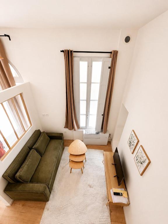 a living room with a couch and a table at Cosy-T2 - Hyper centre Montpellier in Montpellier