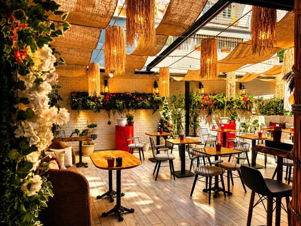 a restaurant with tables and chairs and plants at Viva Rooms in Istanbul