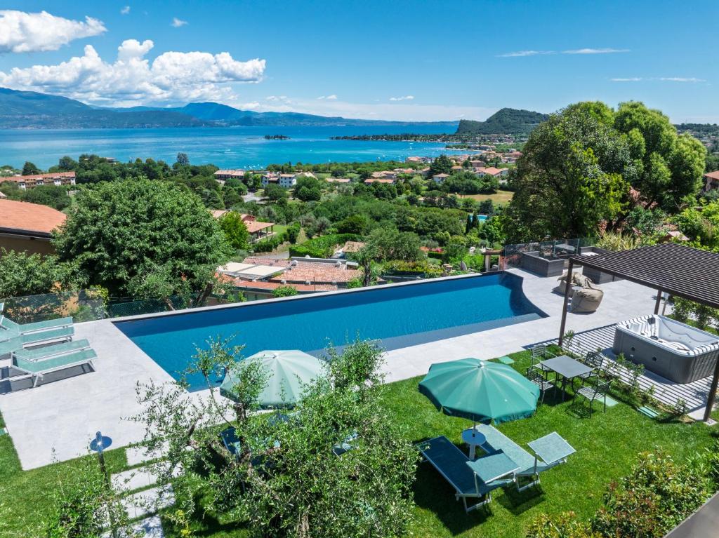 an image of a swimming pool with a view of the water at Casa Veronica in Manerba del Garda