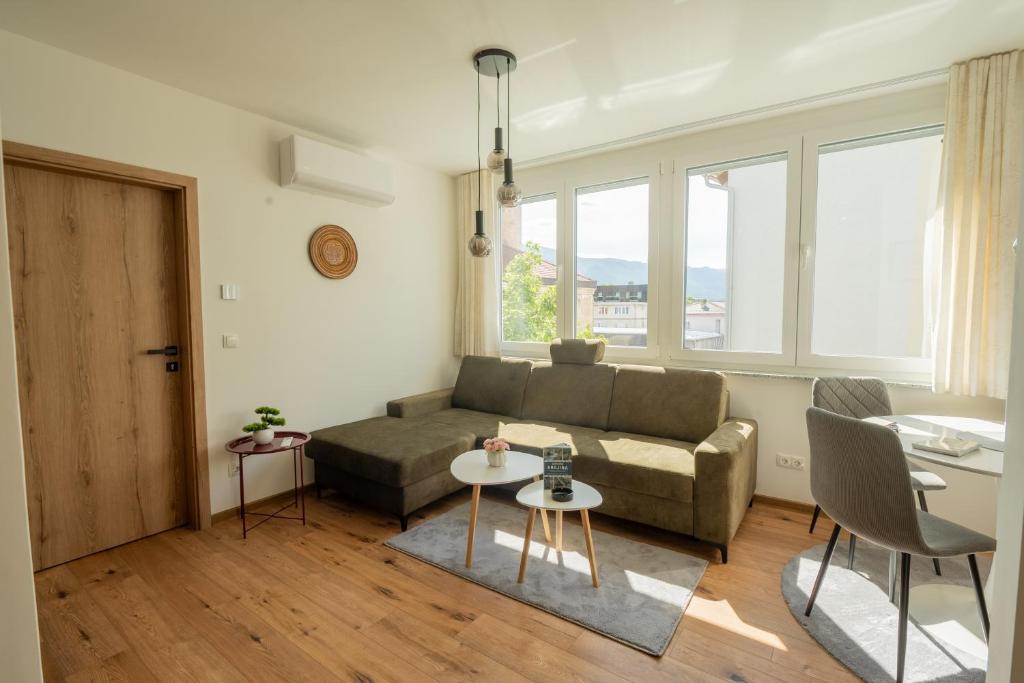 a living room with a couch and a table at Apartment Center Korzo 2 in Bihać