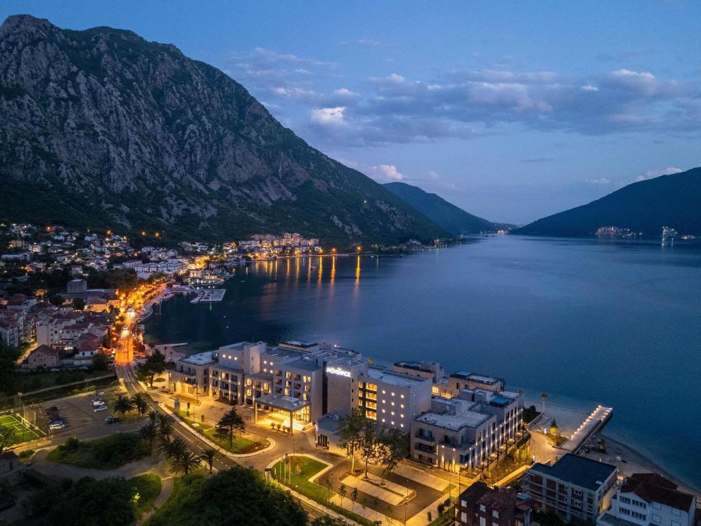 a city next to a large body of water at Mövenpick Hotel & Residences Teuta Kotor Bay in Kotor