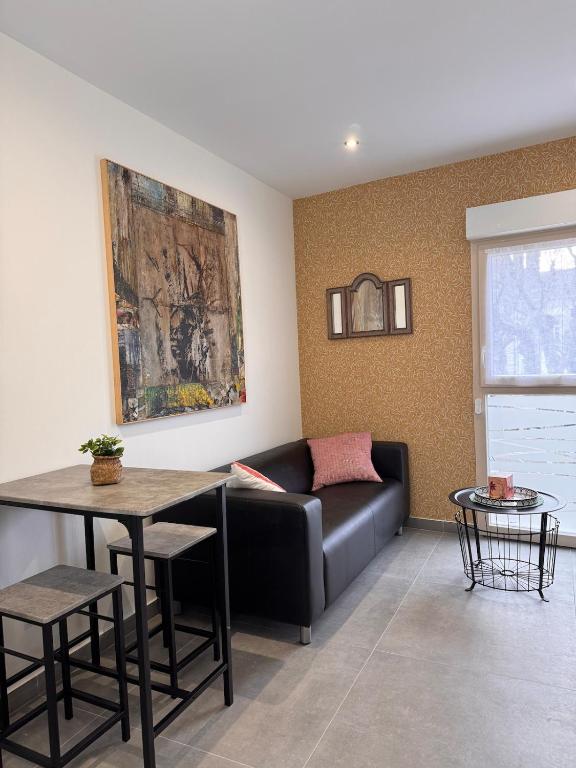 a living room with a couch and a table at 101 - Centre de voiron in Voiron