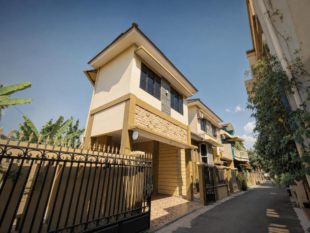 a building with a fence in front of a street at Audi's Homestay near Kotagede in Gondowulung