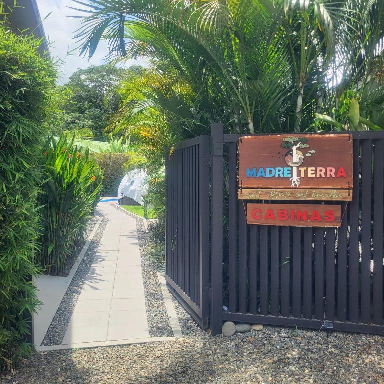 a gate with a sign that reads madeteratera casino at MADRE TERRA in Uvita