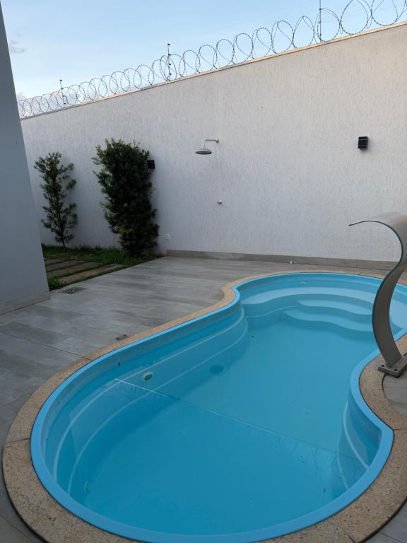 a large blue swimming pool in a building at Casa no Bairro Reserva Real in Montes Claros