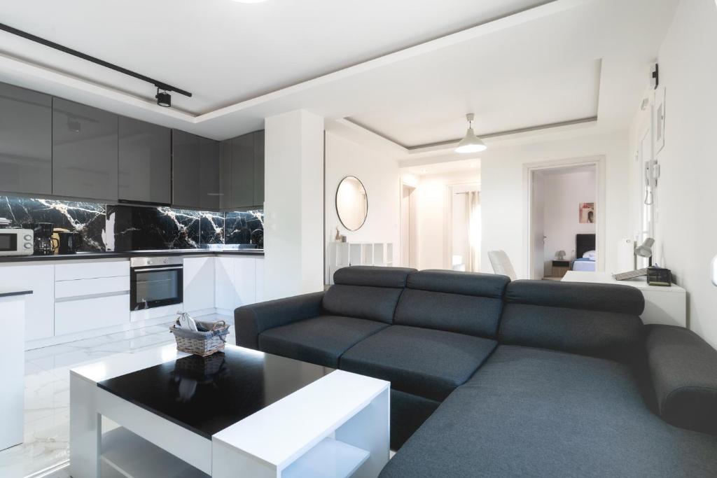 a living room with a couch and a table at Newly built detached house with parking 2 in Larisa