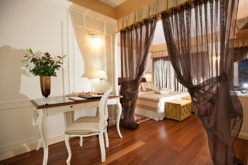 Postel nebo postele na pokoji v ubytování Hotel Calissano