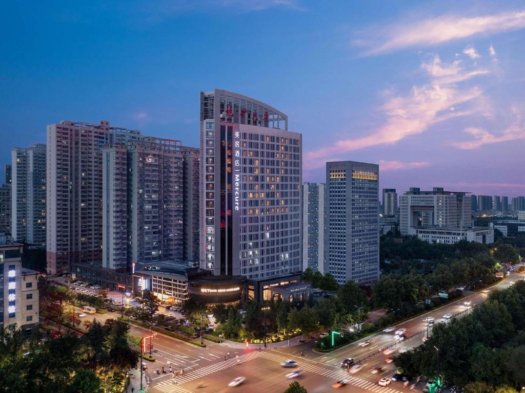 a city with tall buildings and a street with traffic at Mercure Luoyang Downtown in Luoyang