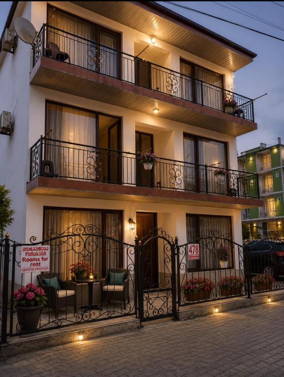 a building with a balcony and a table and chairs at APART HOTEL KOBULETi in Kobuleti
