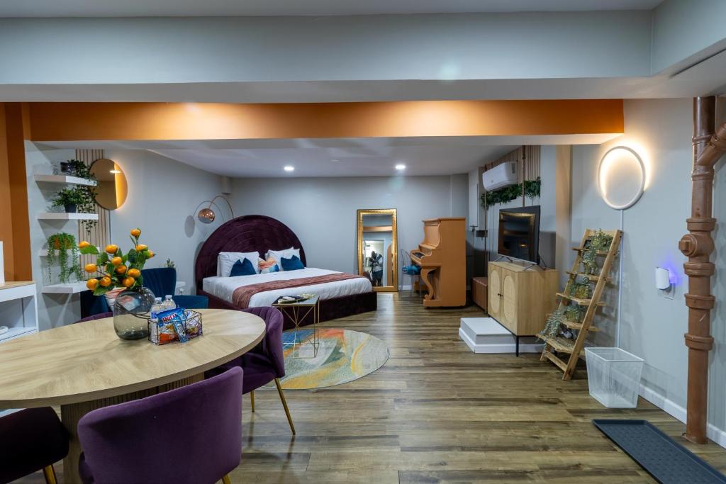 a living room with a bed and a table and a room at VIBES! Free Parking, Piano, King Bed in Washington, D.C.