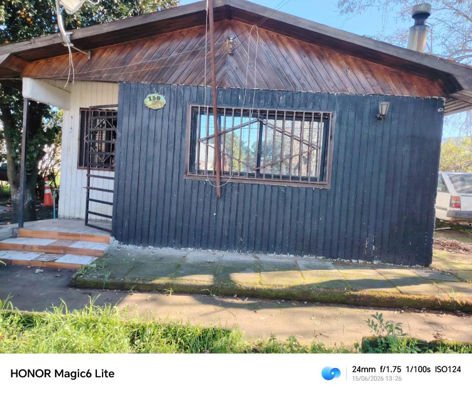 a small blue shack with a window in front of it at Narraverrete family in Chillán