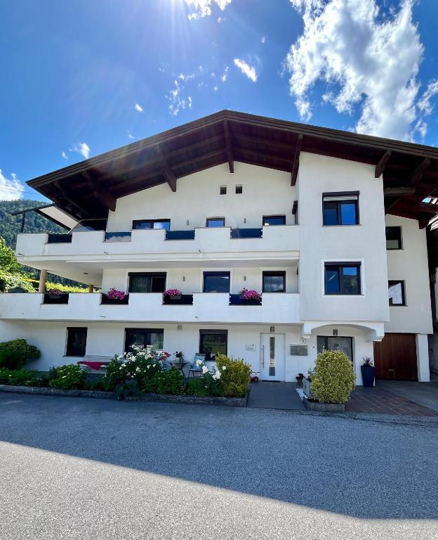 an exterior view of a white building at Ferienwohnung Kreidl in Schlitters